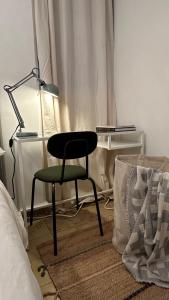 a chair in a room with a lamp and a bed at Room at Centro Histórico in Mexico City