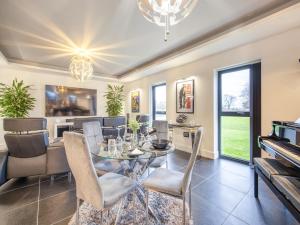 a dining room with a table and chairs and a piano at The Paddocks Retreat in North Thoresby