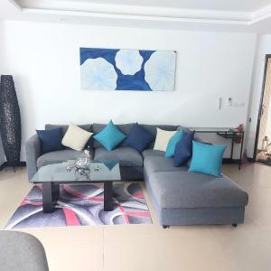 a living room with a couch and a table at Dewa One bedroom suite in Nai Yang Beach