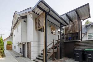 a house with a staircase on the side of it at Spacious 4 BR House in Park Drive in Vancouver