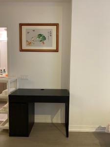 a black desk in a room with a picture on the wall at Cozy holiday home in Toronto