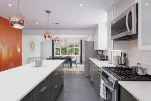 a kitchen with a stove and a counter top at The Spacious Haven at West 27th in Vancouver