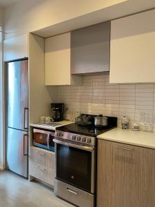 a kitchen with a stove and a refrigerator at Cozy holiday home in Toronto