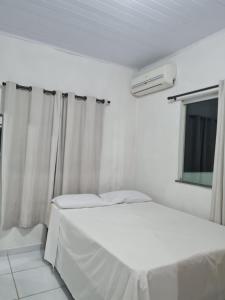 Cama ou camas em um quarto em Casapraiacururupe