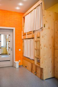 a room with a climbing wall and a ladder at Hostel Forum in Astana