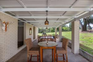 a patio with a table and chairs on it at Laguna Niguel - Acreage in Tuggerah