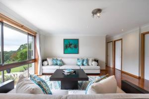a living room with a couch and a table at Laguna Niguel - Acreage in Tuggerah