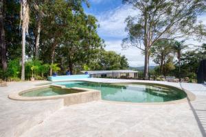 a swimming pool in the middle of a patio at Laguna Niguel - Acreage in Tuggerah