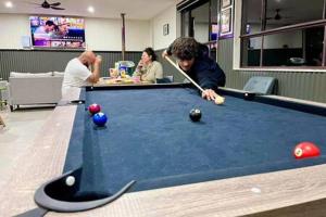 a group of people playing a game of pool at Tiny House 18 at Grampians Edge in Dadswells Bridge