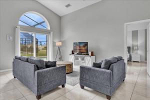 a living room with two couches and a tv at 3 Bedrooms - 2 Bathrooms - Cumbrian Lakes 4695 Cl in Orlando