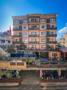 a tall building with a bridge in front of it at Hotel Manang in Kathmandu