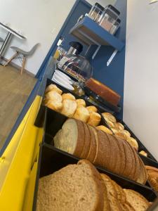 une table recouverte de 2 plateaux de pain et de pain dans l'établissement Mova Express Hotel - CAMPINAS, à Campinas