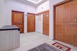 an empty room with wooden doors and a rug at OYO Dream Square in Gwalior