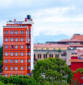 an orange building in a city with buildings at The Luxe Inn Boutique Hotel in Kathmandu