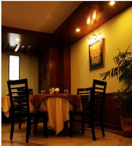 a dining room with a table with chairs and a tableablish at The Luxe Inn Boutique Hotel in Kathmandu
