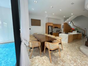 a kitchen and dining room with a table and chairs at Nancy Sweet Condotel Vung Tau 1 in Vung Tau