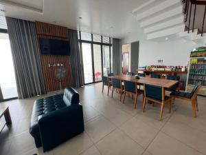 a living room with a couch and a table and chairs at Nancy Sweet Condotel Vung Tau 1 in Vung Tau +2 photos