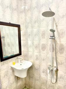 a bathroom with a sink and a shower at Mystic Manor Stonetown B&B in Stone Town