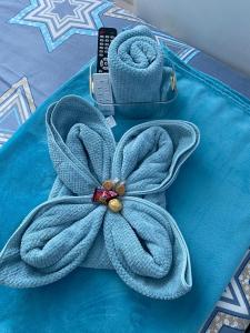 a blue towel with a flower on top of a table at Primo's Crib-The Linear Makati in Manila