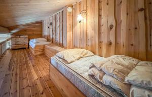 a bedroom with two beds in a wooden cabin at 6 Bedroom Cozy Home In Kvam in Kvam