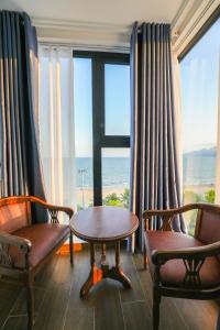 a room with two chairs and a table and a window at Gia Kiên Hotel in Quy Nhon