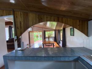 a living room with an archway in a house at Jardín Del Bosque in Bijagua