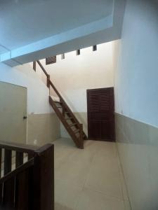 a room with a staircase and a stair case at top loft battambang in Battambang