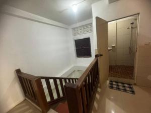 a bathroom with a walk in shower and a stairway with a walk in shower at top loft battambang in Battambang