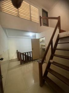 a room with a staircase and a stair case at top loft battambang in Battambang