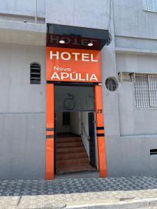 a hotel entrance with a sign on the side of a building at Hotel Novo Apúlia in Sao Paulo