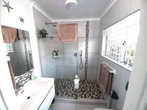 a bathroom with a shower and a sink at Close to the sea - Upstairs Sea Facing En Suite Bedroom In Main House in Durban
