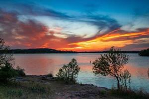 a sunset over a large body of water at Lake Beach Access & Views, 5kings! in Buchanan Dam