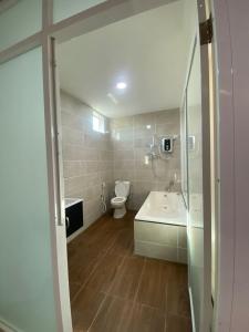 a bathroom with a toilet and a sink at Codidik Hotel in Kuantan