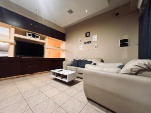 a living room with two couches and a flat screen tv at Duplex Centrico in Termas de Río Hondo