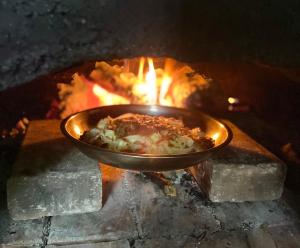 a bowl of food in a fire oven at Kung Nok Tha Resort Nakhon Si Thammarat in Nakhon Si Thammarat