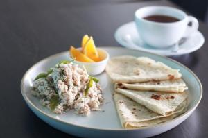 a plate of food on a table with a cup of coffee at Fulidhoo Hathaa Retreat in Fulidhoo