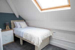 a bedroom with a bed and a skylight at Beach Apartments - 1st Floor Cleveleys in Cleveleys