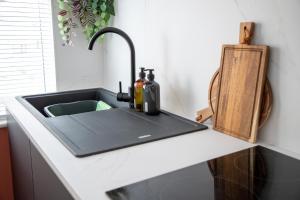 a kitchen counter with a sink with aktop at Beach Apartments - 1st Floor Cleveleys in Cleveleys