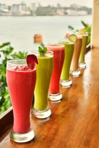una fila de diferentes bebidas de colores sentadas en una mesa en Tulia Old Town en Mombasa