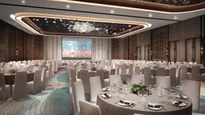 a banquet hall with white tables and white chairs at Sheraton Kuching Hotel in Kuching