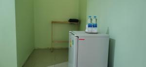 a small refrigerator with water bottles on top of it at Palm Kaew Resort Krabi in Krabi town