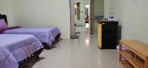 a hospital room with two beds and a table at Palm Kaew Resort Krabi in Krabi