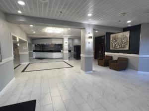 a lobby with couches and a fireplace in a building at The Lodge Hotel and Banquets in Bridgeton