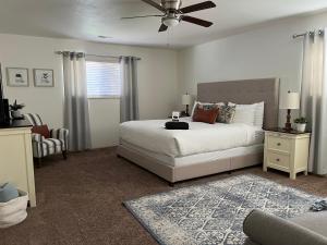 a bedroom with a bed and a ceiling fan at Swiss Corner Cottage - Private-Heated Indoor Pool in Santa Clara