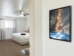 a bedroom with a bed and a tv on a wall at Swiss Corner Cottage - Private-Heated Indoor Pool in Santa Clara