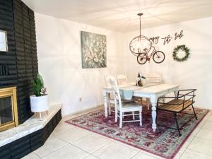 a dining room with a table and chairs and a fireplace at Swiss Corner Cottage - Private-Heated Indoor Pool in Santa Clara