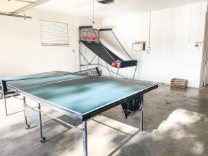 a ping pong table in a room with a net at Swiss Corner Cottage - Private-Heated Indoor Pool in Santa Clara