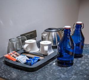 a counter with two blue glass bottles on a table at East Park Inn in New Delhi