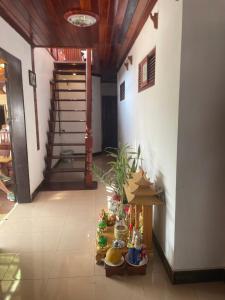 a hallway of a house with a table and stairs at Ouis NamKhan Place House in Luang Prabang