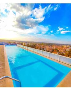 a large swimming pool on the roof of a building at Luxe Oasis in Nairobi